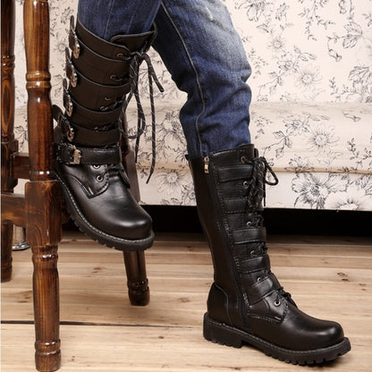 A man sitting on a chair wearing comfortable Mid-Calf Leather Motorcycle Riding Boots.