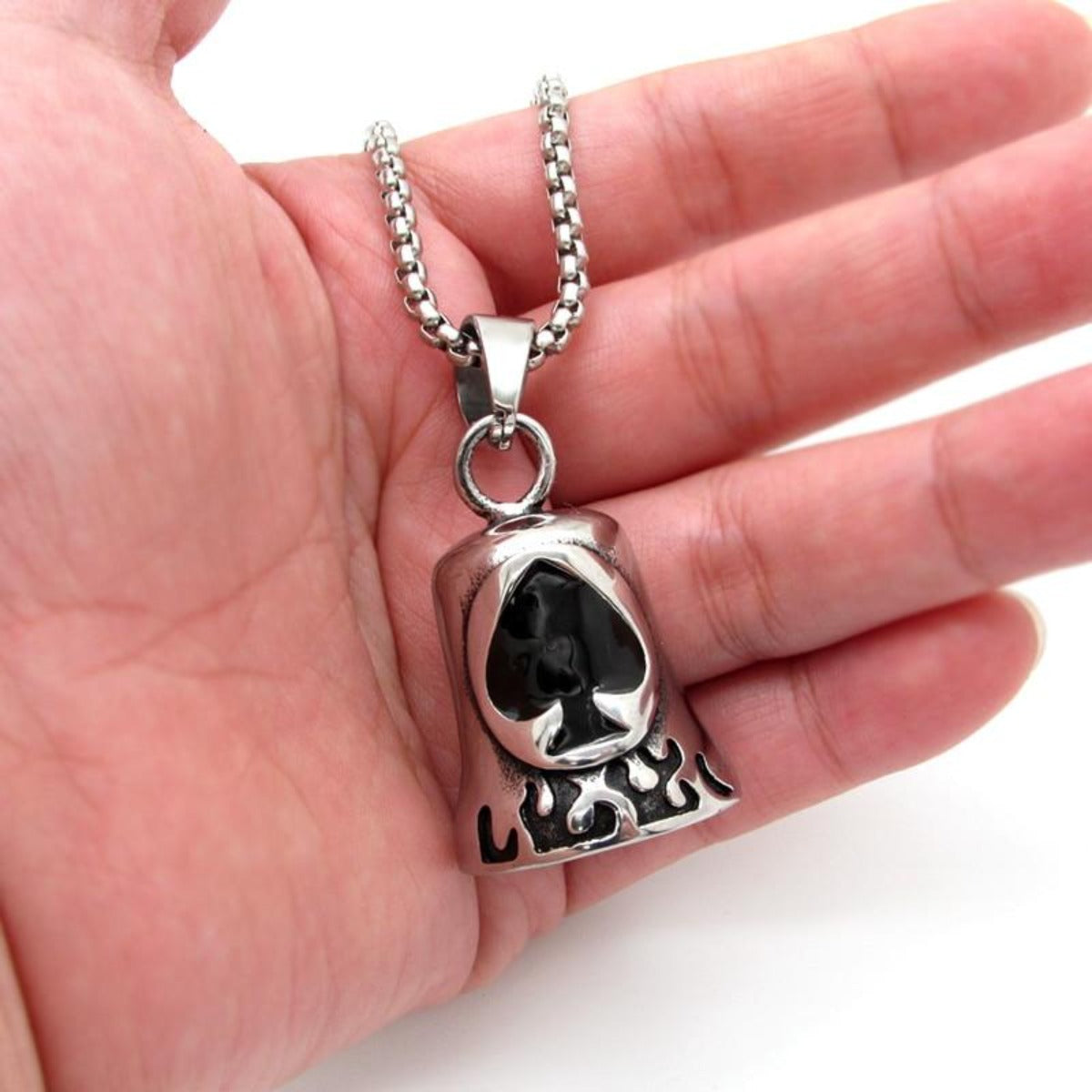 A biker holding a Stainless Steel Biker Spade Gremlin Bell, symbolizing road protection in the biker community.