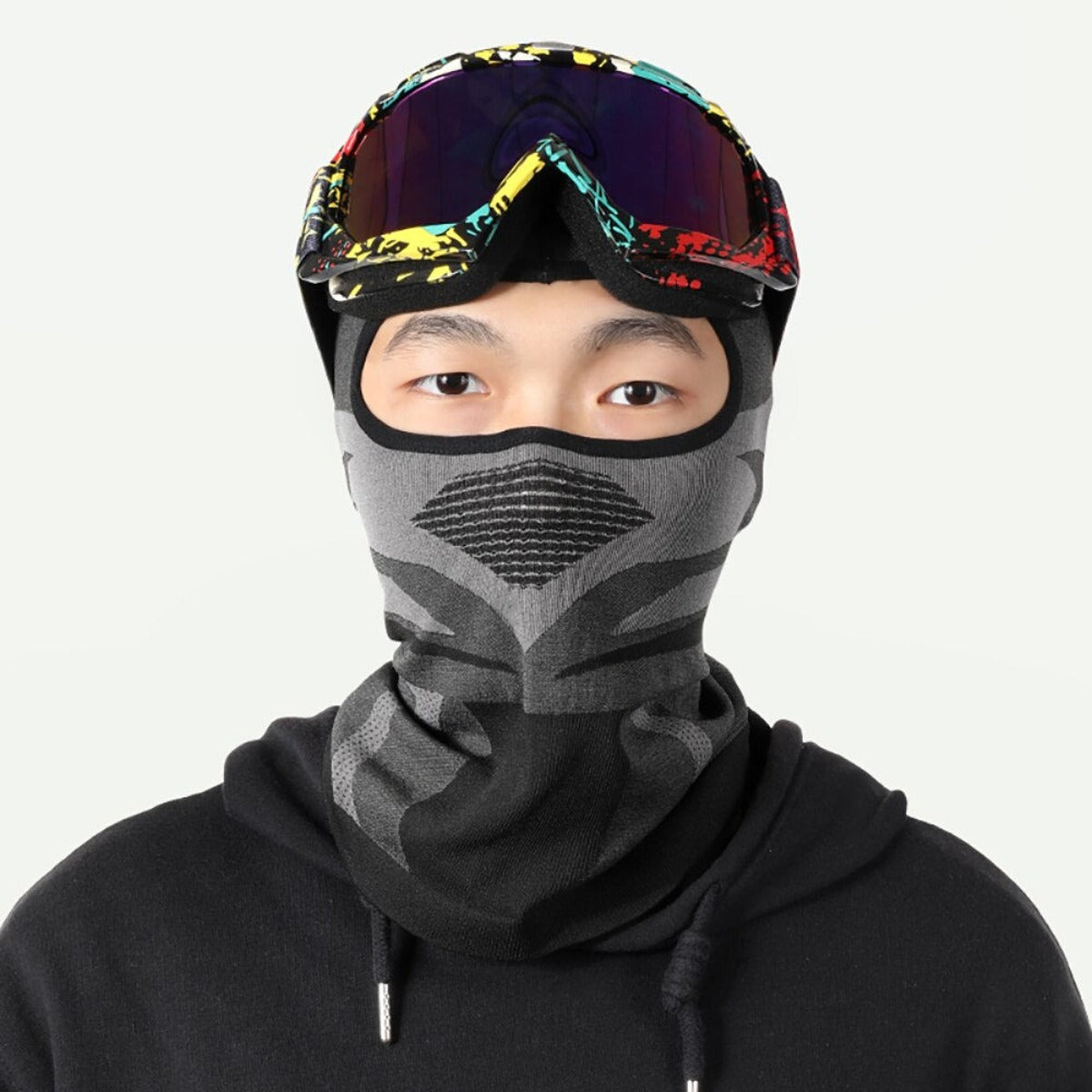A motorcycle rider wearing a Breathable Motorcycle Full Face Cover and goggles.