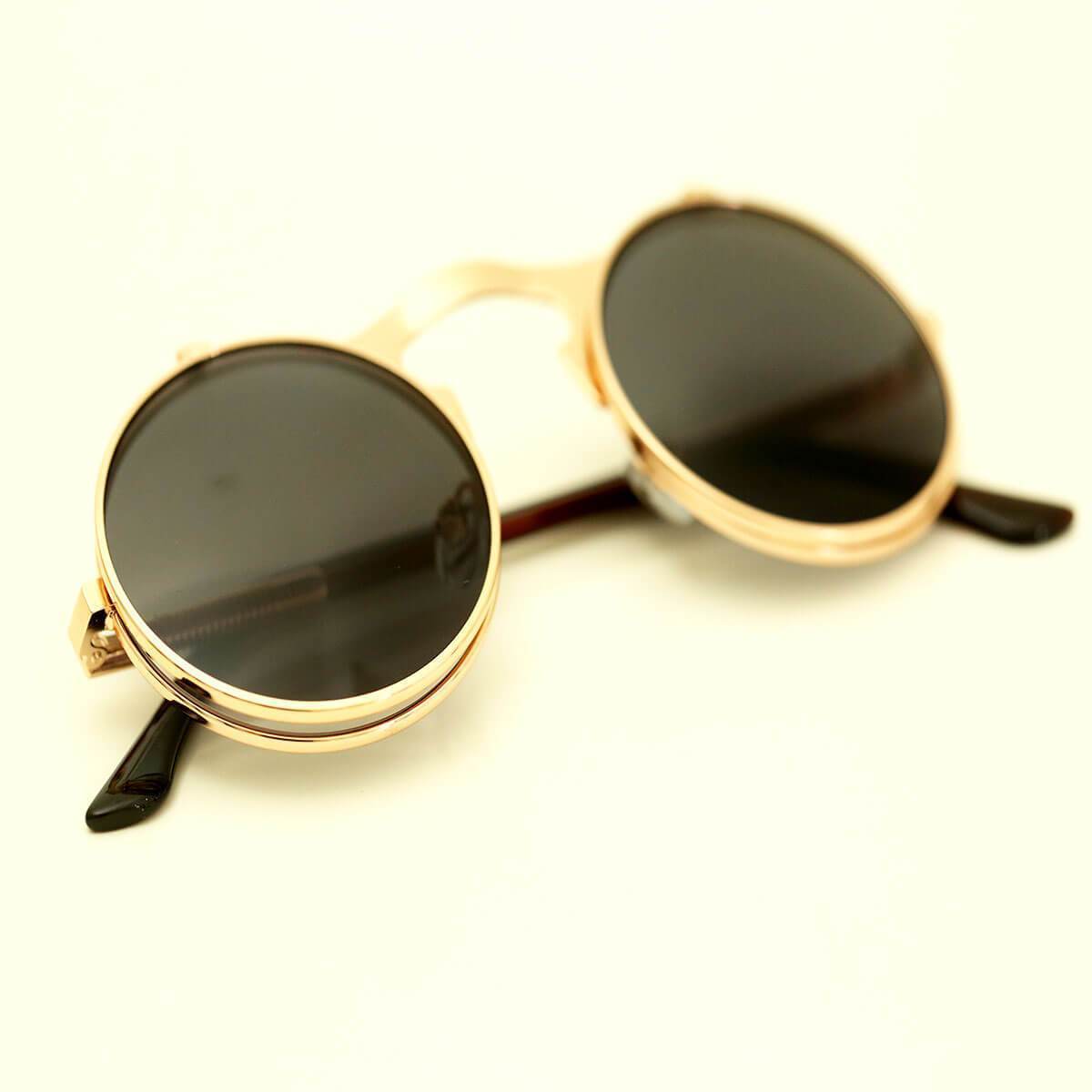 A pair of Steampunk Flip-Up Round Double Lens Sunglasses on a white surface.