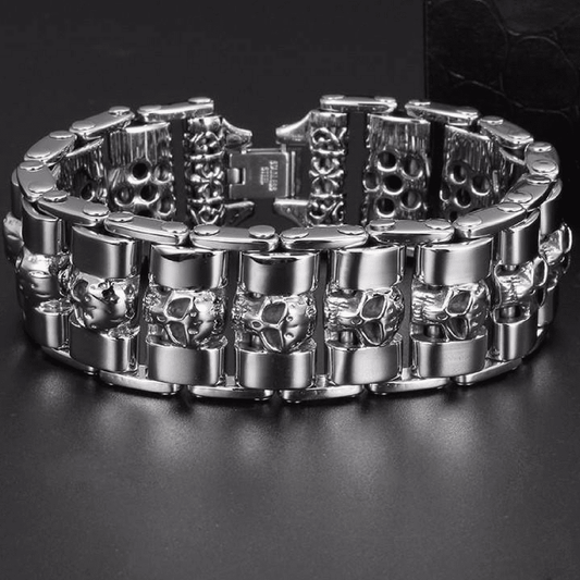 A Stainless Steel Fashion Wide Skull Bracelet, 8.3 x 0.9 in featuring a pattern of small skull designs arranged around the band, displayed against a black background. The medieval style bracelet combines classic charm with an edgy twist.
